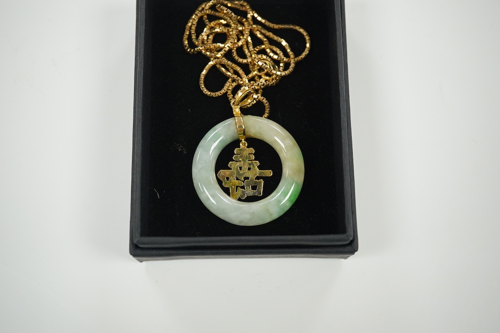 A Chinese jadeite and gold circular pendant and box link chain, stamped 585. Condition - good